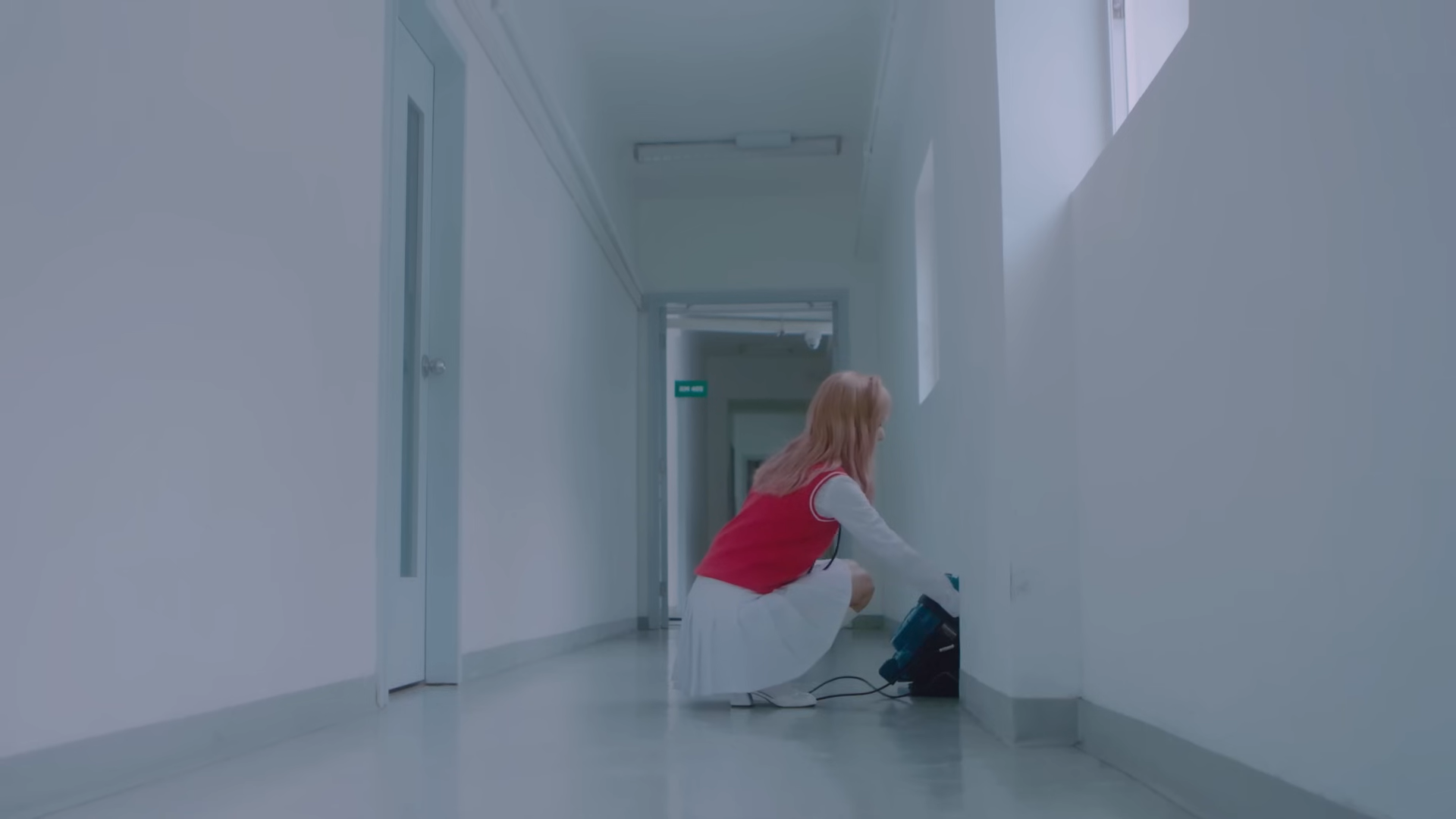 Vivi kneeling over the backpack.